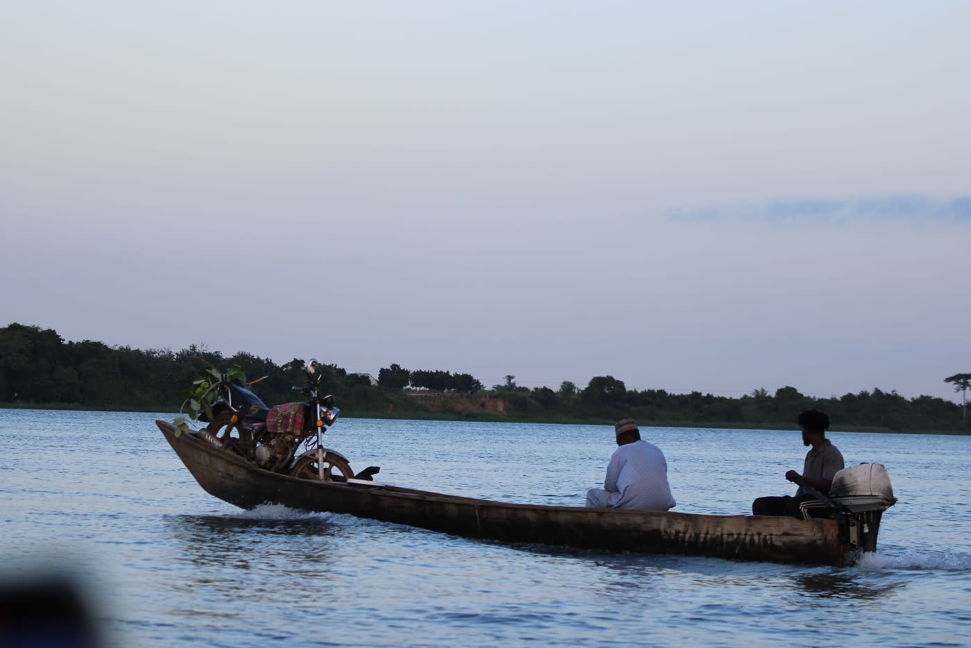 A canoe crossing the Volta River at dusk