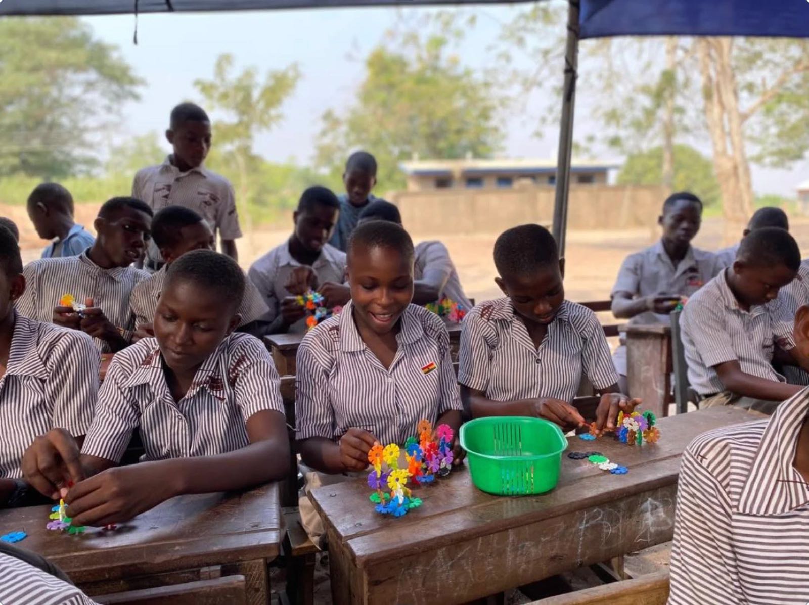Girls in Ghana building colorful STEAME models at their desks