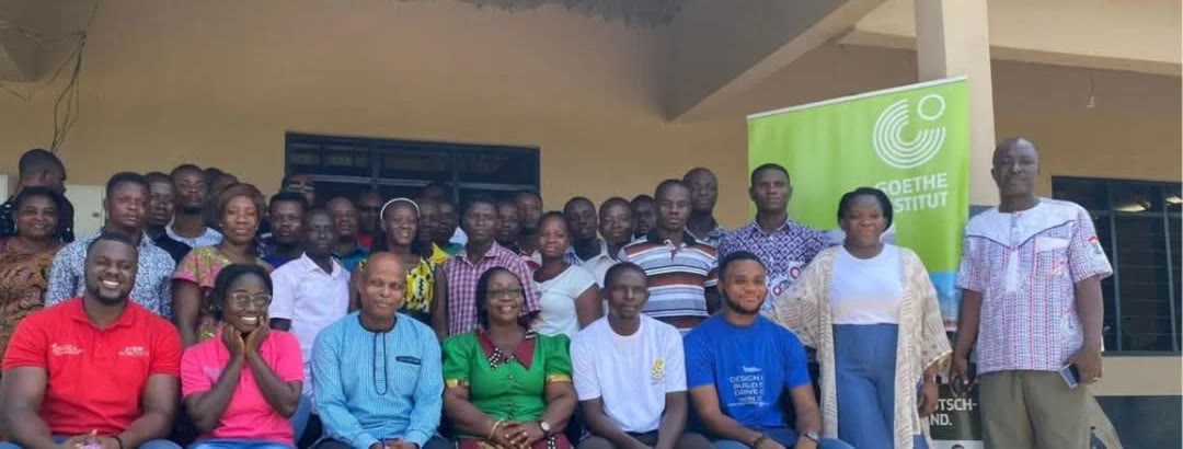 A large group of teachers, seated and standing, after a training workshop in Ghana
