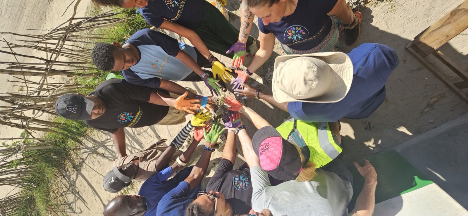 Volunteers and students showing painted hands at Mijomboni Primary School in Kenya