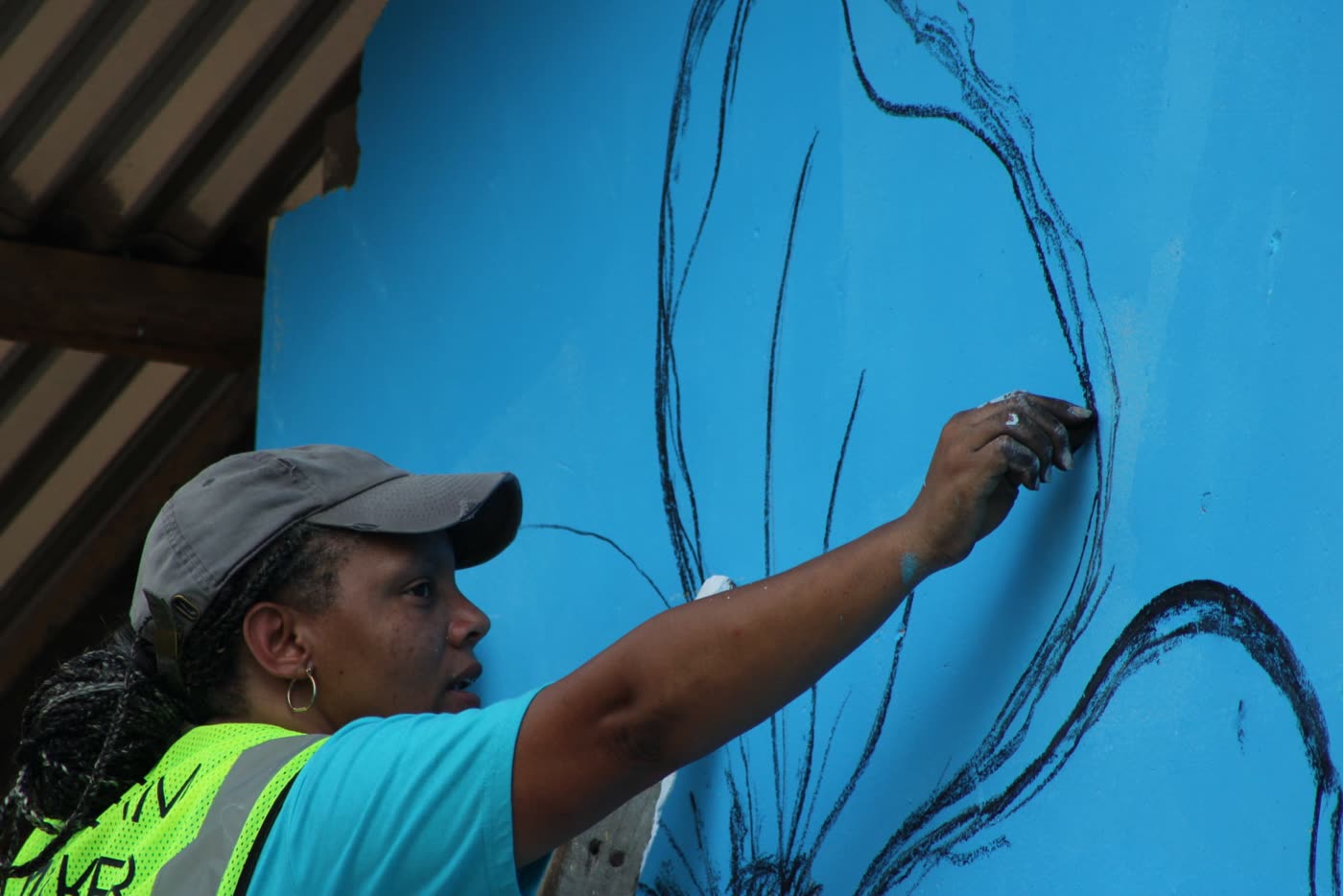 A volunteer painting a flower