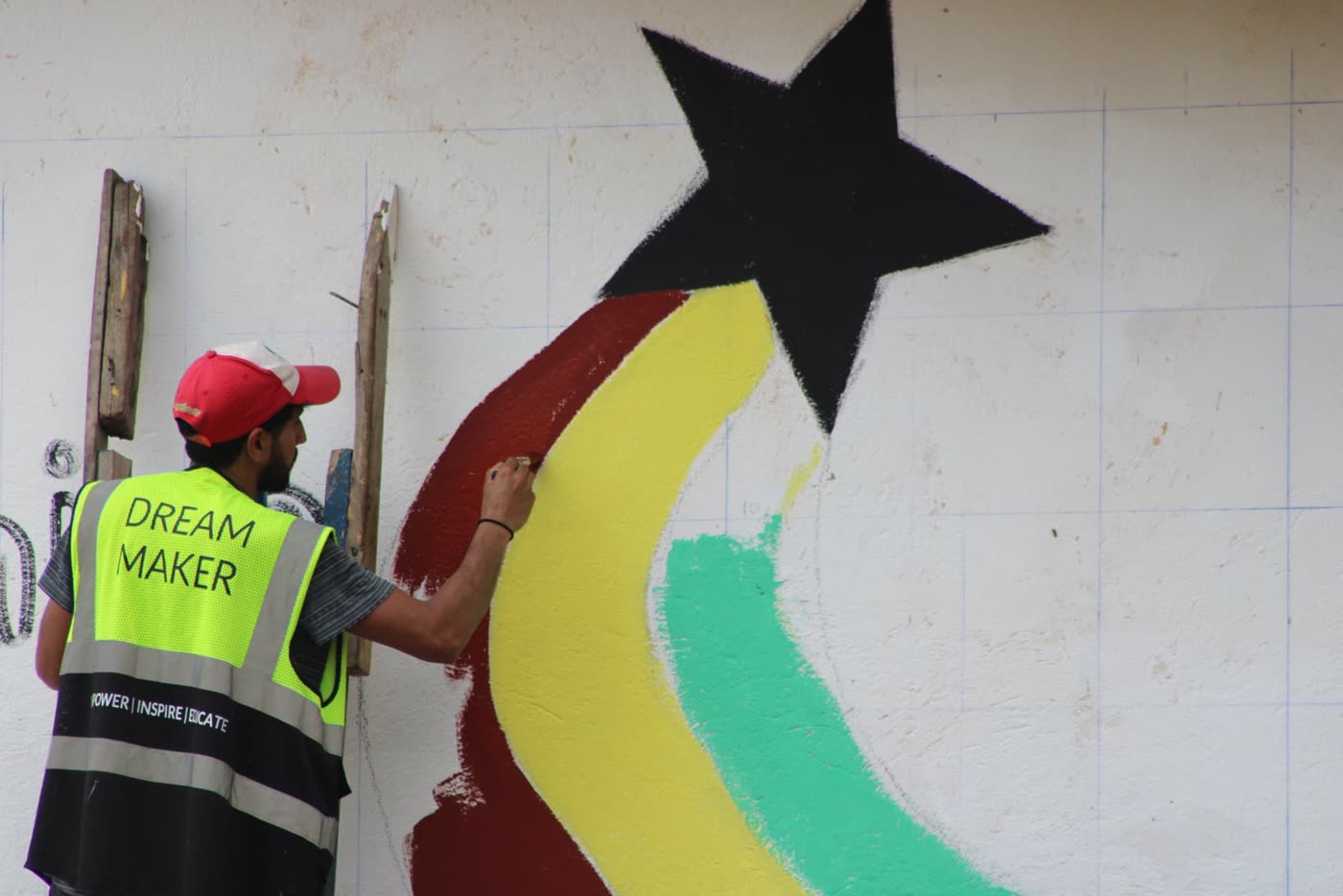 Volunteers painting a shooting star